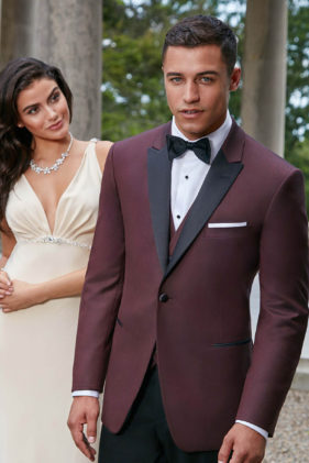 Man in burgundy tuxedo with woman.