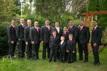 Groomsmen and boys in black suits.