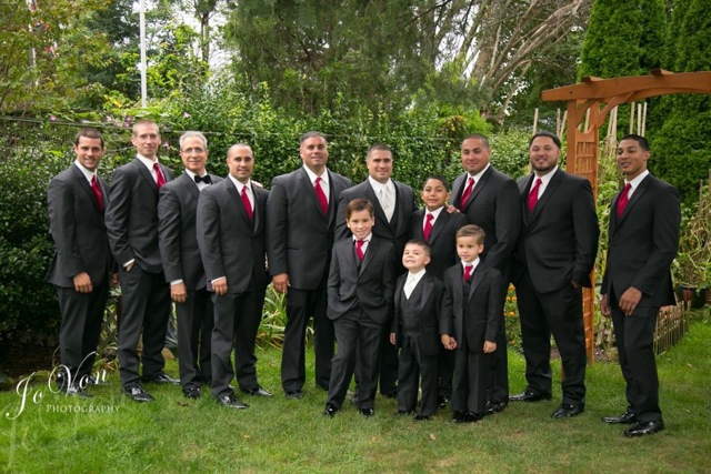 Groomsmen and boys in black suits.