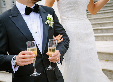 Bride and groom toasting champagne.