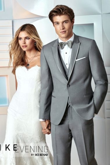 Groom in gray suit with bride.