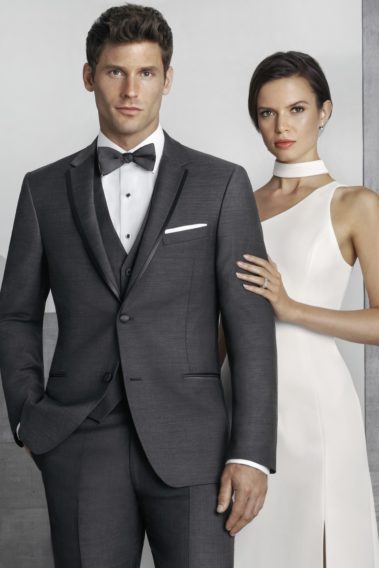 Here's an alt tag for the image: Elegant couple in formal wedding attire.
