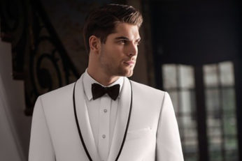 Man in white tuxedo, black bow tie.