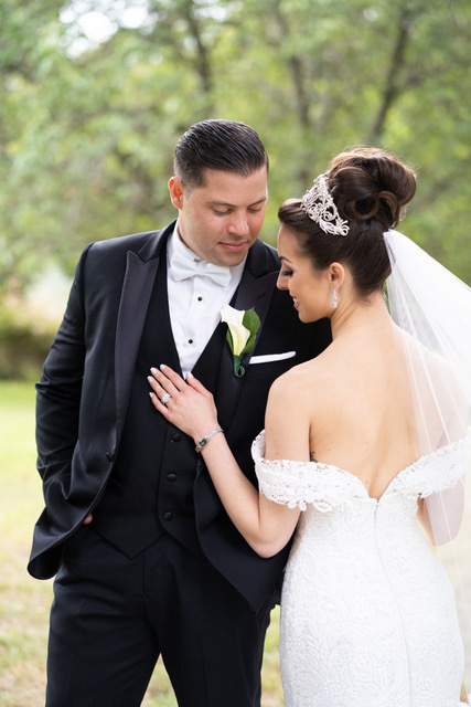 Bride and groom embracing on wedding day.
