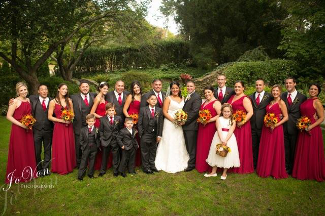 Wedding party in red and black attire.