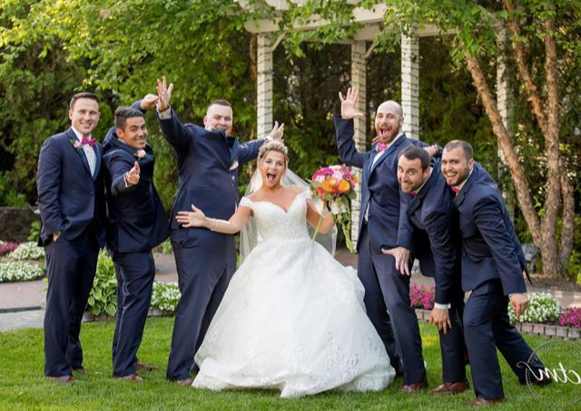 Bride and groomsmen posing playfully.