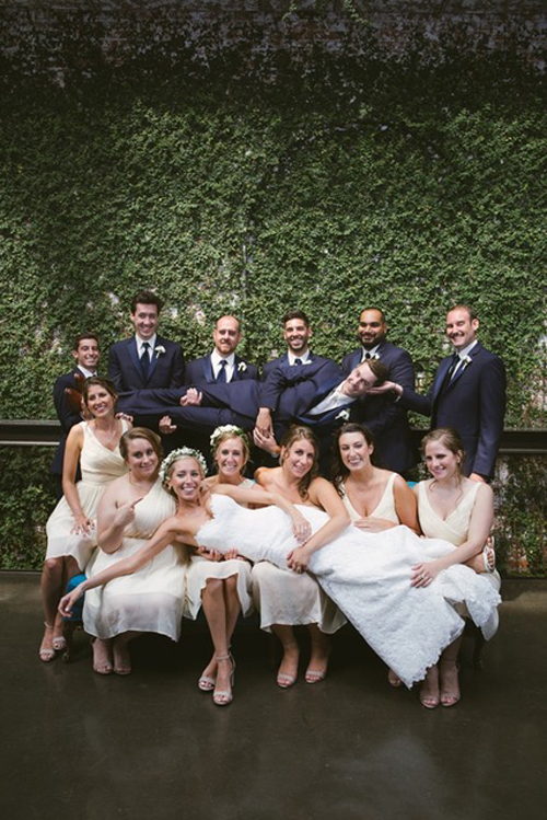 Wedding party, bride lifted by groomsmen.