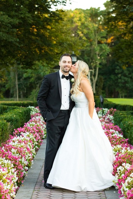 Bride kissing groom on wedding day.