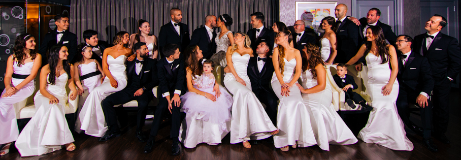 Large wedding party in white gowns.