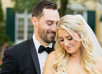 Here's an alt tag for the image: Happy newlywed couple embracing outdoors.