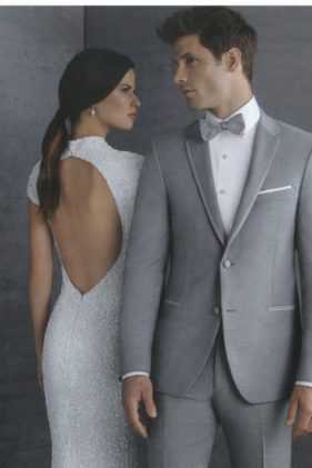 Elegant couple in gray suit and white dress.