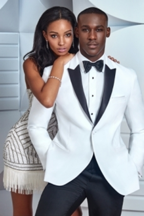 Couple in formal wear; he in white tuxedo.
