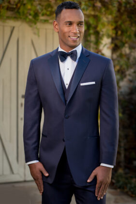 Man in navy tuxedo, bow tie.