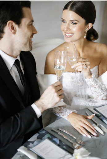 Bride and groom toasting with champagne.